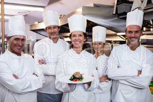 Team of chefs with one presenting a dish