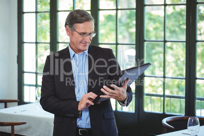 Smiling businessman holding a wallet