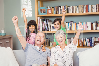 Grandchildren with grandparents gesturing success sign