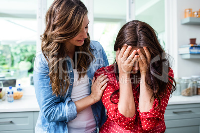 Woman comforting worried friend