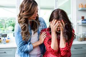 Woman comforting worried friend