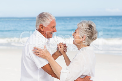 Senior couple dancing on the beach