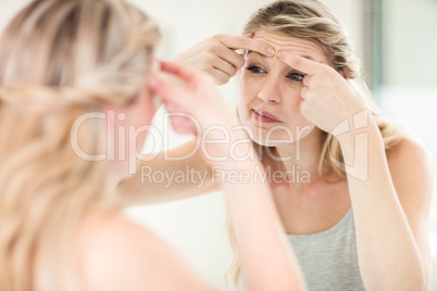 Young woman looking in mirror