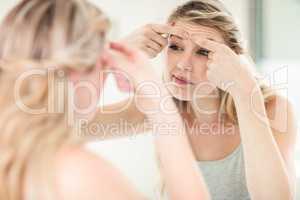 Young woman looking in mirror