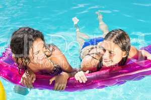Happy friends enjoying in the swimming pool