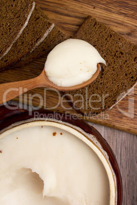 Melted fat and brown bread on chopping board