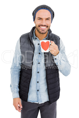 Happy young man holding coffee mug