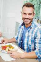 Portrait of smiling man having food
