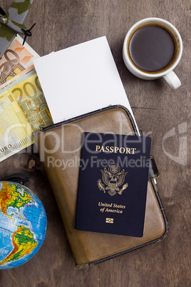 Passport, diary, cup of coffee and money.