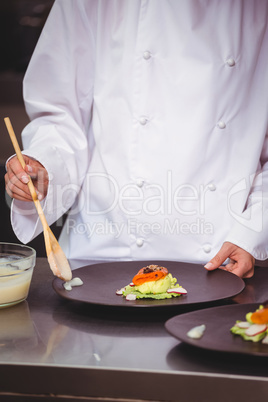 Chef putting sauce on a dish