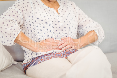 Midsection of senior woman suffering from stomach pain