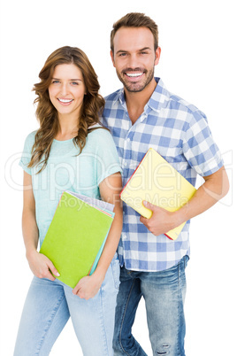 Happy young couple holding book and folder