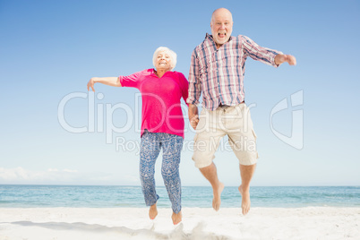 Happy senior couple jumping