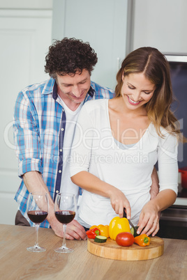 Smiling wife with husband in kitchen