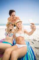 Young friends taking a selfie on the beach