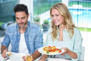 Smiling couple with pizza