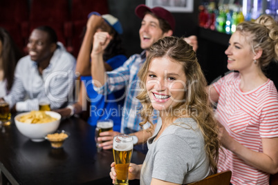 Happy friends watching sport