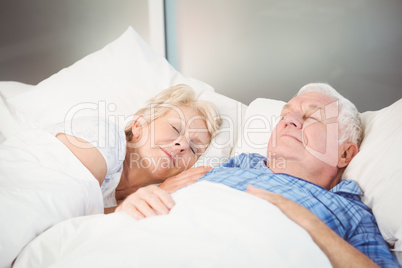 Couple sleeping together on bed