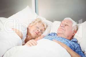 Couple sleeping together on bed