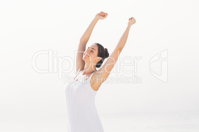 Beautiful woman stretching on the beach