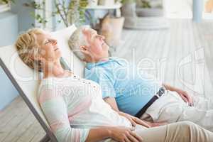 Senior couple relaxing on lounge chair
