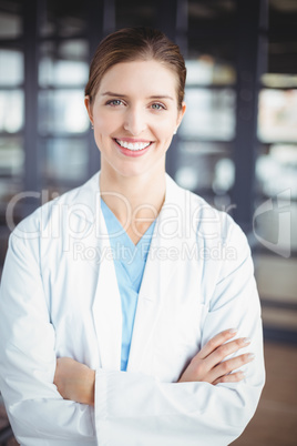 Portrait of smiling female doctor with arms crossed
