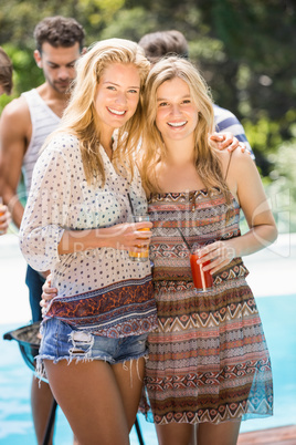 Young women smiling and having juice together