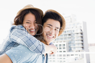 Young man giving a piggyback ride to woman