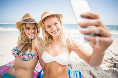 Two friends in bikini taking a selfie