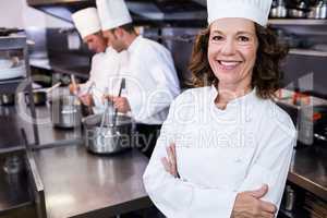 Portrait of smiling chef in commercial kitchen