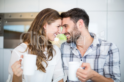 Couple with coffee mug looking at each other