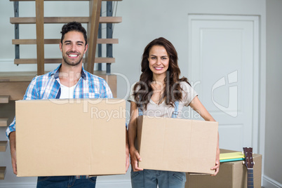 Cheerful couple with boxes