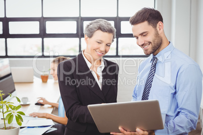 Business people looking in digital tablet at office