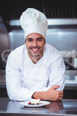 Chef leaning on the counter with a dessert