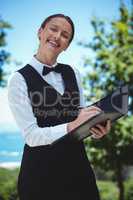 Smiling waitress taking an order