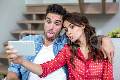 Couple making faces while taking selfie