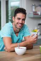 Portrait of cheerful man using phone