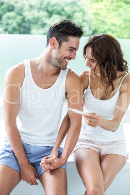 Happy couple with pregnancy test