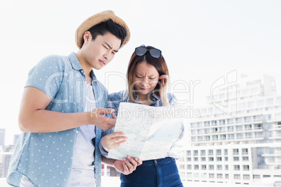 Young couple looking at map for direction