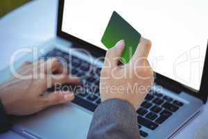 Businesswoman using her credit card to buy online