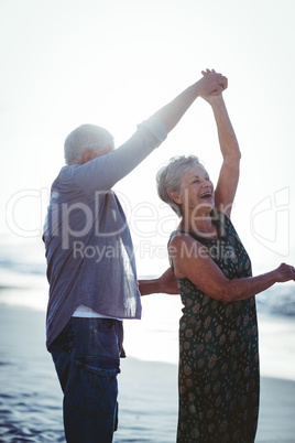 Senior couple dancing at the beach