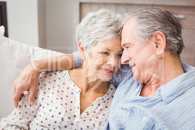 High angle view of romantic senior couple sitting on sofa