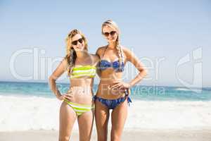 Portrait of two happy women standing on the beach