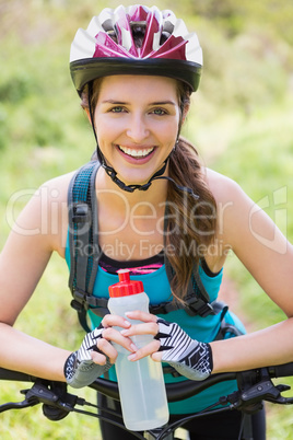 Smiling woman standing next to her bike