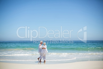 Senior couple embracing at the beach