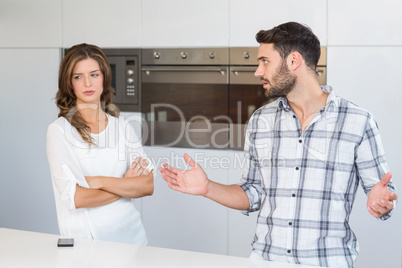 Man explaining upset woman at home