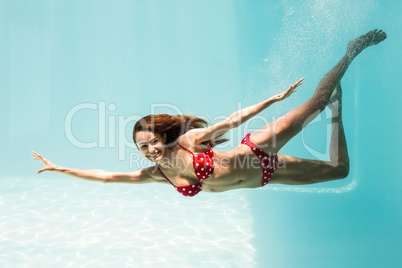 Portrait of smiling young woman swimming