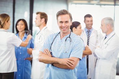 Happy male doctor standing with arms crossed Happy male doctor standing with arms crossed