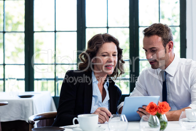 Business colleagues using a laptop while having a meeting