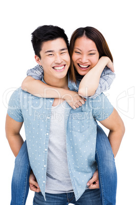 Young man giving piggyback ride to woman